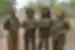 Group of 4 members of the black mambas stand proud in the African brush