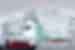 Zodiacs and kayaks marvel at an arched iceberg off the coast of Antarctica