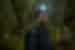 Intrepid leader with headlamp laughs with joy on night walk in the Amazon Peru