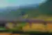 Bullet train on high rail line passing through the mountain backed agricultural landscape of Yunnan Province China