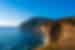 View from the coast look out on clear blue sky day, with blue waters and golden cliff edge, Maria Island, Australia