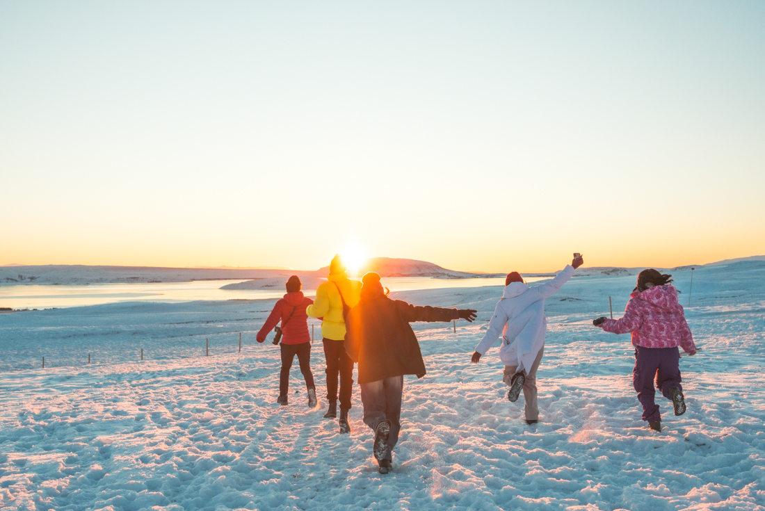 Overcome with joy, travellers take off into sunset