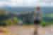 Intrepid traveller stands high taking in Presbischtor Gate in Czechia's mountains