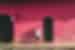 Traveller leans against a bright pink painted building in the streets of Suchitoto in El Salvador