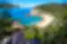 Traveller in sun hat looks out at Magnetic Island Beach