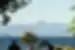 View of Mount Tongariro with a lake and travellers in the foreground, New Zealand