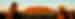 Two travellers admiring Uluru at sunset