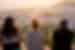 Group of travellers watching the sunset over colourful buildings in Chefchaouen, Morocco