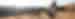Hikers on rocks going up a slope in the sunshine in Arches National Park