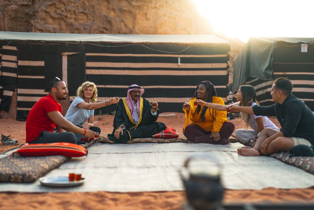Intrepid travellers and leader cheers tea with Bedouin local in Jordan near Wadi Rum