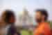 Travellers smile and laugh with each other looking out at the Taj Mahal in Agra