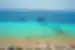 Deck chairs on beach with view of boats and ocean, Brac Island, Croatia