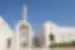 Exterior of the Grand Mosque in Muscat with travellers carrying through to the interior in Oman