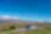 Travellers' tour bus pulled over on side of road so travellers can enjoy the view of Mount Tongariro, New Zealand