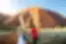 Intrepid travellers and leader approach the foot of Uluru for a talk