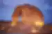 Travellers seated in the sand enjoying twilight at Jabal Alfil, elephant rock, Al Ula, Saudi Arabia
