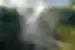 Crashing water creating a mist around thick greenery at Victoria Falls, Zimbabwe